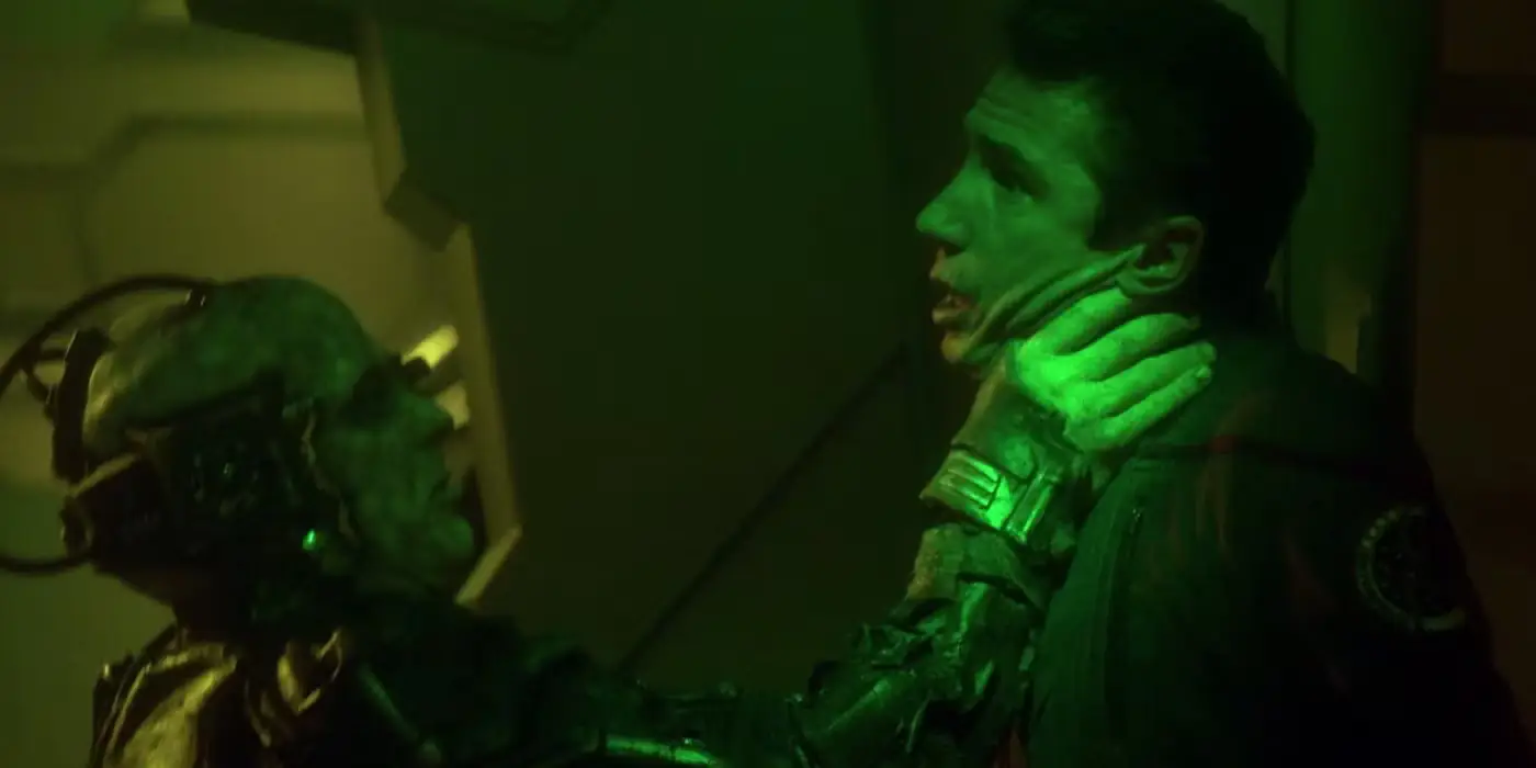 A Borg drone holding up a Star Trek cadet high by the neck